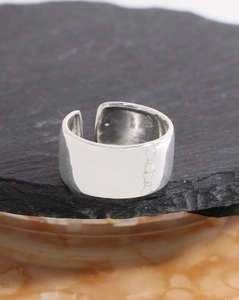 Macro shot of a wide S925 sterling silver open ring with unique bamboo-style textures