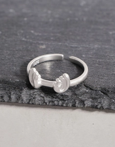 Macro view of S925 sterling silver wave ring showing the hallmark and matte texture