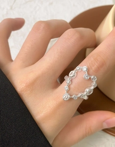 Detail of S925 silver heart ring featuring cubic zirconia accents on a female hand