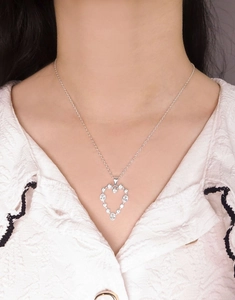 Close-up of S925 silver heart pendant necklace with zircon stones on a model