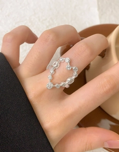 Close-up of S925 silver heart-shaped ring with cubic zirconia worn on finger