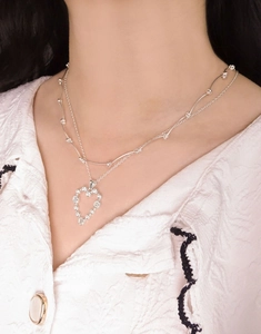 Close-up of double-layer S925 silver necklace with zircon heart pendant on model