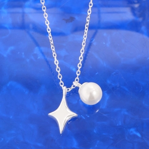 S925 sterling silver necklace featuring starburst pendant and white pearl on blue background