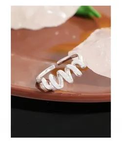 Vue macro d'une bague spirale en argent S925 montrant la texture fine et le poinçon