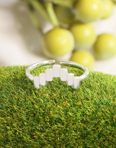 Macro shot of S925 sterling silver stamp on minimalist geometric square V-shaped ring