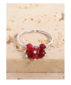 Detail of S925 sterling silver ring featuring red faceted crystal berry cluster on stone