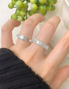 Close-up of stacked S925 sterling silver water drop rings with beaded relief details
