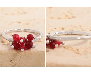 Detail of S925 sterling silver ring with seven red faceted beads and adjustable band