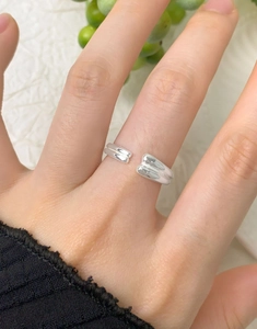 Close-up of minimalist S925 sterling silver double-layer teardrop open ring on finger