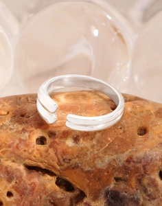 Detail of S925 sterling silver stamp on minimalist double-layered teardrop open ring
