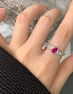 Macro view of S925 sterling silver ring with oval ruby and pavé zircon detailing
