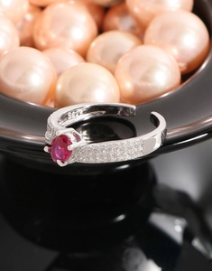 Macro shot of S925 sterling silver ring featuring a ruby-red oval zircon and micro-pavé details