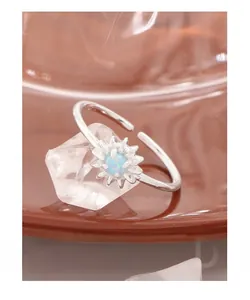 Makroaufnahme von Gänseblümchen-Ring aus Silber mit Opalstein und feinen Sonnenstrahl-Blättern