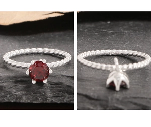 Macro shot of S925 sterling silver stamp on twisted band with garnet stone ring