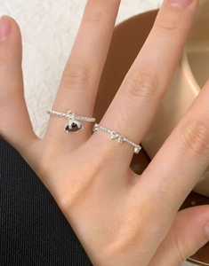 Detailed view of S925 silver twist ring with zircon pendant and dainty bow design
