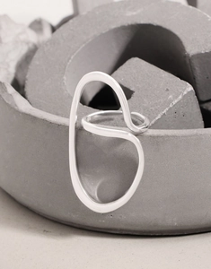 Macro detail of S925 sterling silver ring with irregular abstract geometric curves