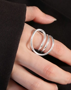 Detail of minimalist S925 sterling silver multilayer spiral ring on woman's hand