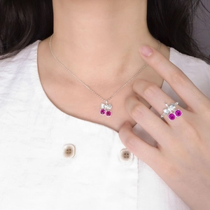 S925 silver cherry bow jewelry set with pink stones on a model featuring ring and necklace