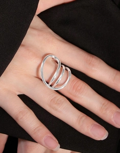 Macro shot of curved S925 sterling silver minimalist ring worn on index finger
