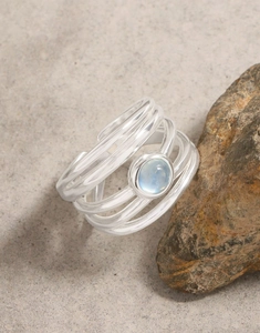 Macro detail of S925 sterling silver multi-layer wrap ring with blue aquamarine gemstone