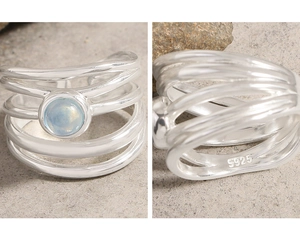 Macro detail of the S925 silver stamp and blue gemstone on wavy irregular ring band
