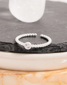 Close-up of S925 sterling silver beaded open ring with a round bezel-set cubic zirconia