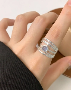 Macro detail of S925 sterling silver stacked rings featuring a blue aquamarine gemstone