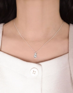 Close-up of S925 sterling silver star and bead pendant necklace worn on a model's neck