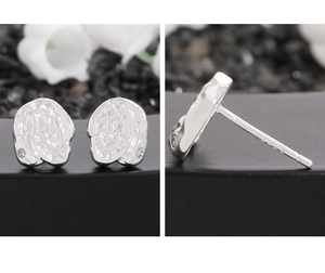 Macro detail of S925 sterling silver stamp and liquid lava texture on silver earring