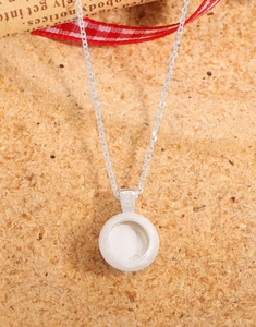 Macro shot of S925 sterling silver necklace with matte brushed finish pendant