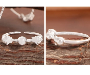Close-up of S925 sterling silver stamp and star bubble ring detail with white stone