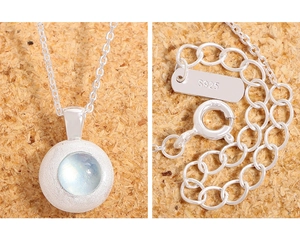 Detail of S925 sterling silver necklace with matte finish and blue natural aquamarine