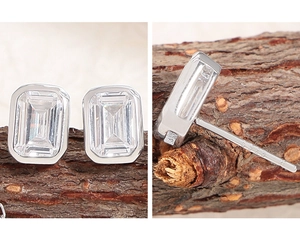 Macro detail of S925 sterling silver square zircon stud earrings with emerald cut stones