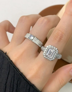 Close-up of S925 sterling silver twist band rings with emerald cut cubic zirconia on hand