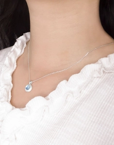 Close-up of S925 sterling silver necklace with matte brushed blue aquamarine pendant