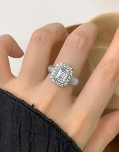 Macro shot of S925 silver ring featuring emerald cut zircon and twisted ribbed band