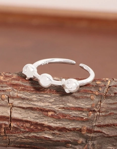 Close-up of S925 sterling silver star and bead ring detailing with engraved hallmark