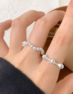 Detailed view of S925 sterling silver beaded ring and star-shaped finger ring on hand