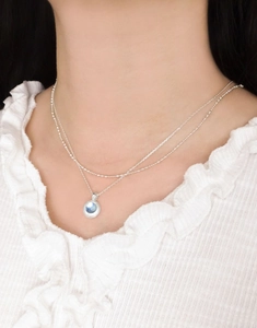 Detail of s925 silver double-layered necklace with blue natural aquamarine pendant