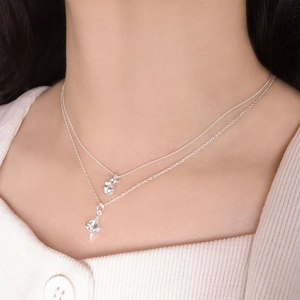Double-layered 925 sterling silver star and bubble pendant necklace on model