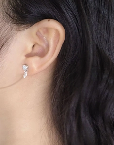 Close-up of minimalist S925 sterling silver teardrop zircon stud earrings on model
