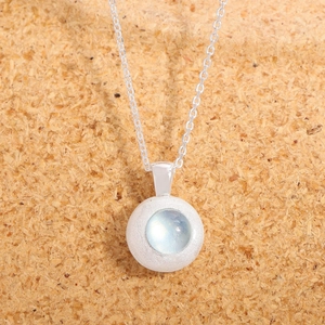 Natural aquamarine S925 silver necklace with frosted round pendant on cork background