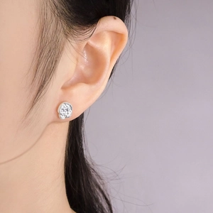 S925 sterling silver stud earrings with irregular molten lava texture on female model