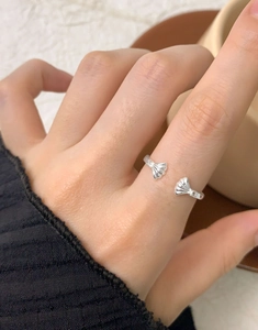 Detailed macro view of S925 sterling silver ginkgo leaf open ring with zircon accents