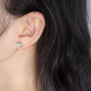 Elegant emerald cut zircon stud earrings in S925 sterling silver worn by a model