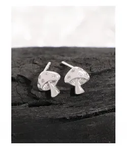 Close-up of S925 sterling silver mushroom stud earrings with sparkling cubic zirconia