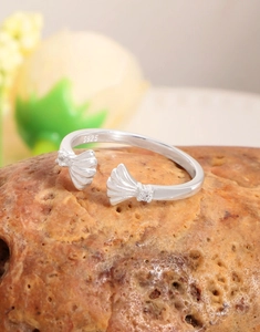 Macro shot of S925 sterling silver shell ring with crystal inlay on natural stone