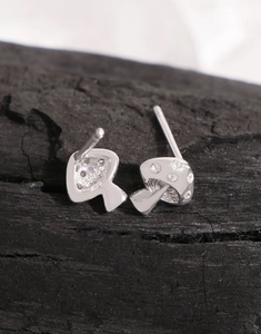 Macro detail of S925 silver mushroom stud earrings with cubic zirconia inlay design