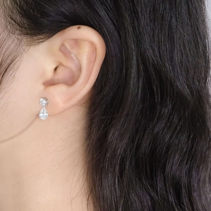 Minimalist S925 silver stud earrings with pear-shaped cubic zirconia on female model