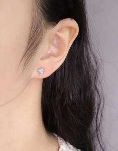 Minimalist S925 sterling silver mushroom stud earring worn on a model's earlobe